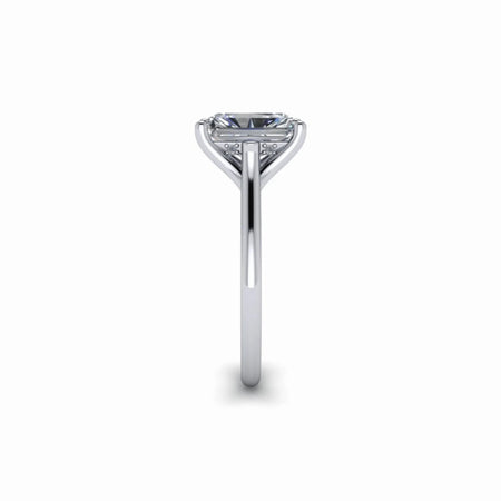 Side view of a solitaire diamond engagement ring with a thin white gold band