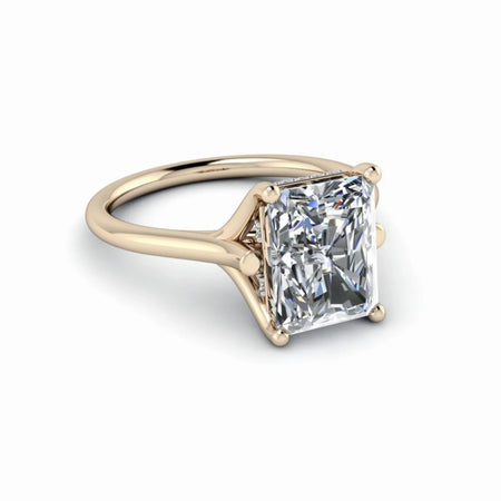 Radiant cut diamond solitaire engagement ring with yellow gold band