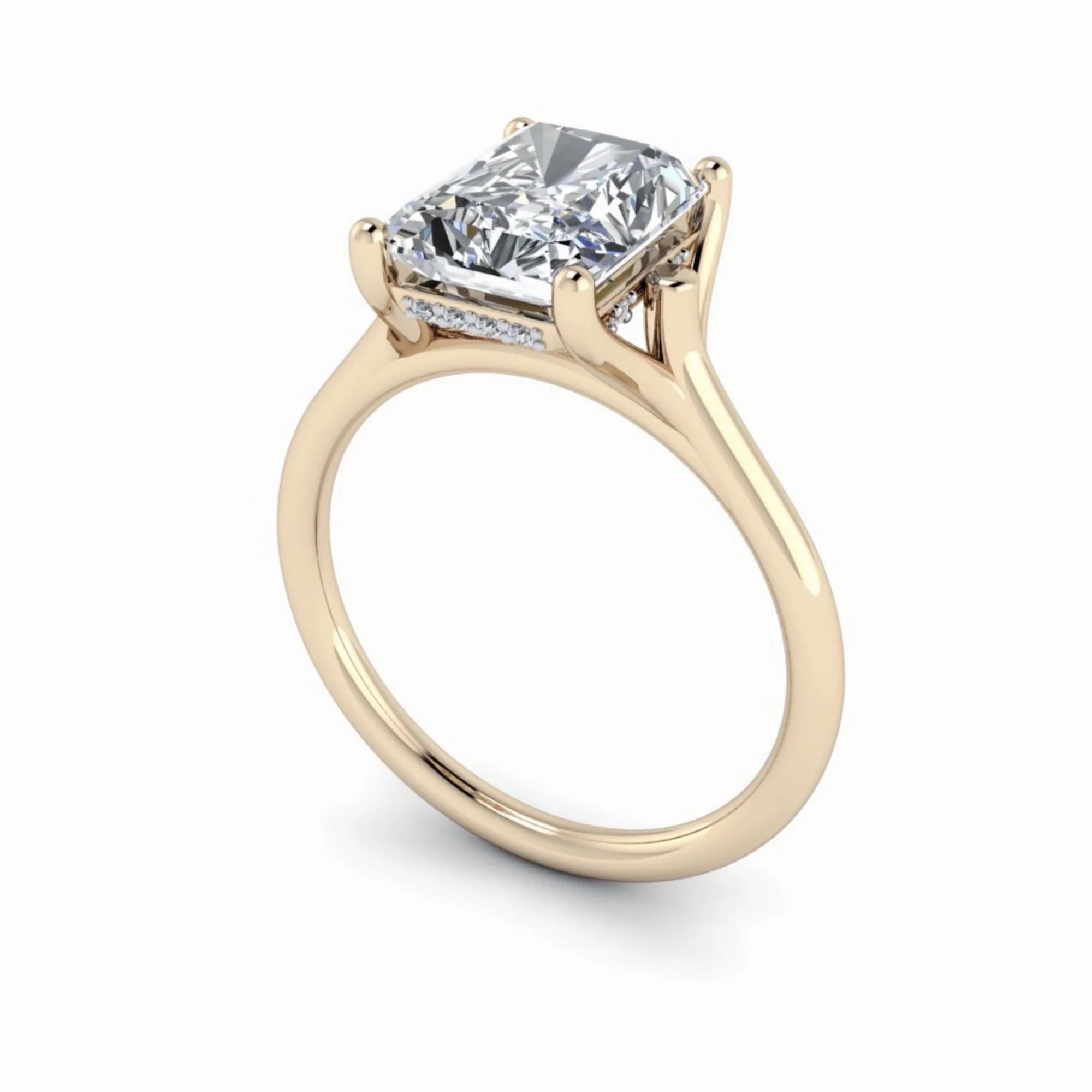 Yellow gold engagement ring with radiant-cut diamond solitaire and pavé detailing