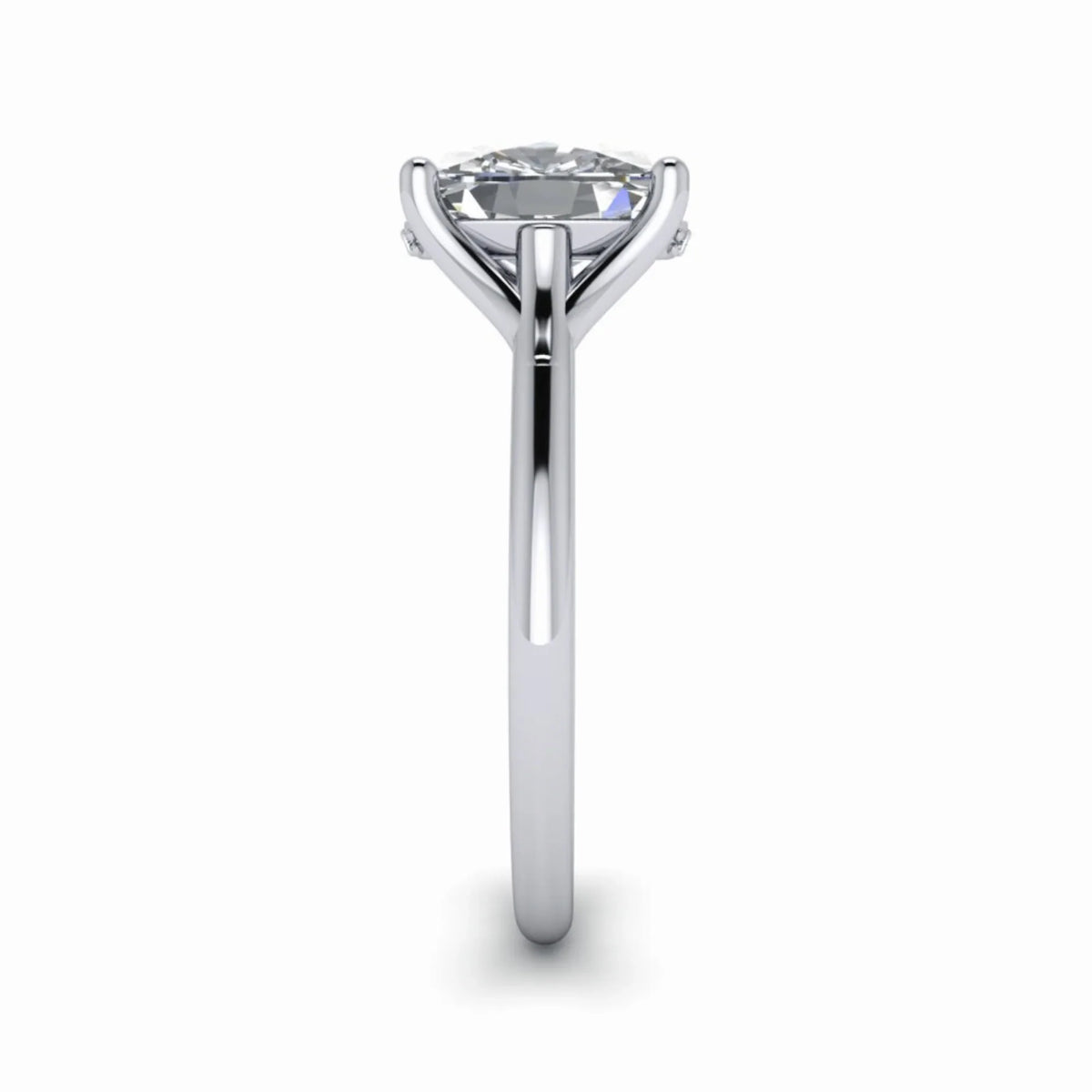 Side view of solitaire engagement ring with round diamond and sleek white gold band
