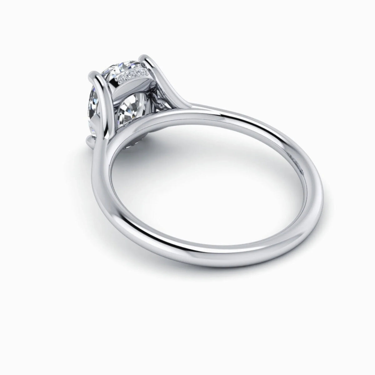 White gold custom engagement ring with round diamond solitaire and pavé accents