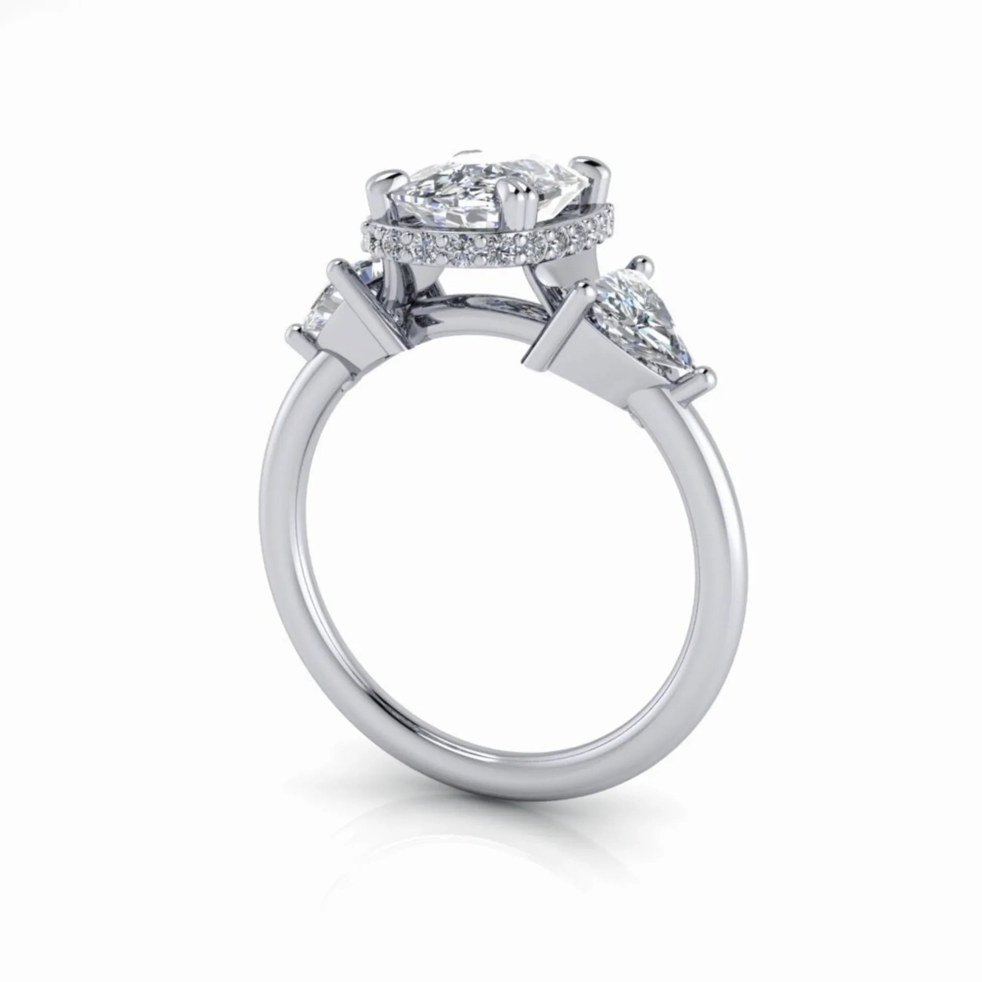 Side view of a custom diamond engagement ring with three stones and pavé halo setting