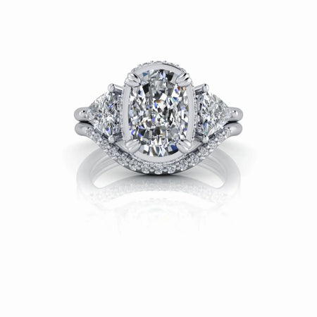 Oval diamond engagement ring with side stones and pavé band on white background