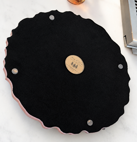 Black felt jewelry display tray with scalloped pink edge, ideal for custom engagement rings and bespoke jewelry presentation.