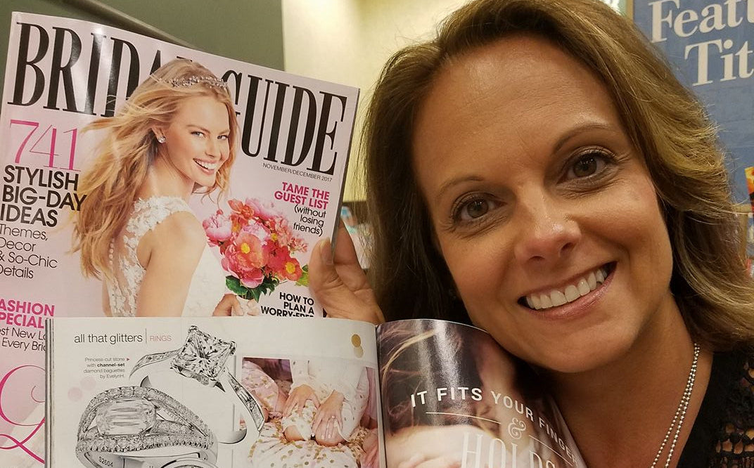 Woman holding a magazine with jewelry advertisements and a product packaging.