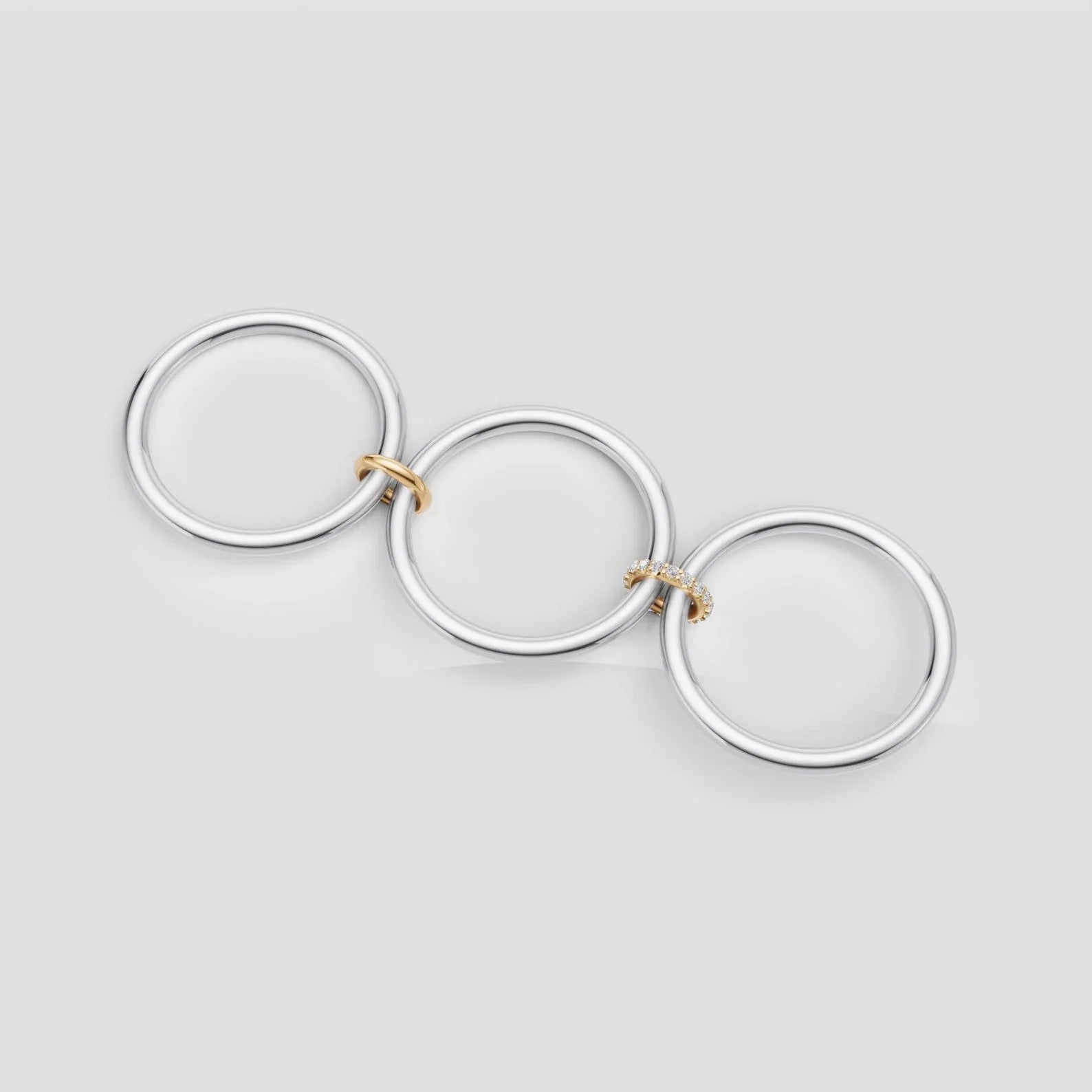 Elegant interlocking rings with diamonds and gold accents, perfect for custom engagement jewelry.