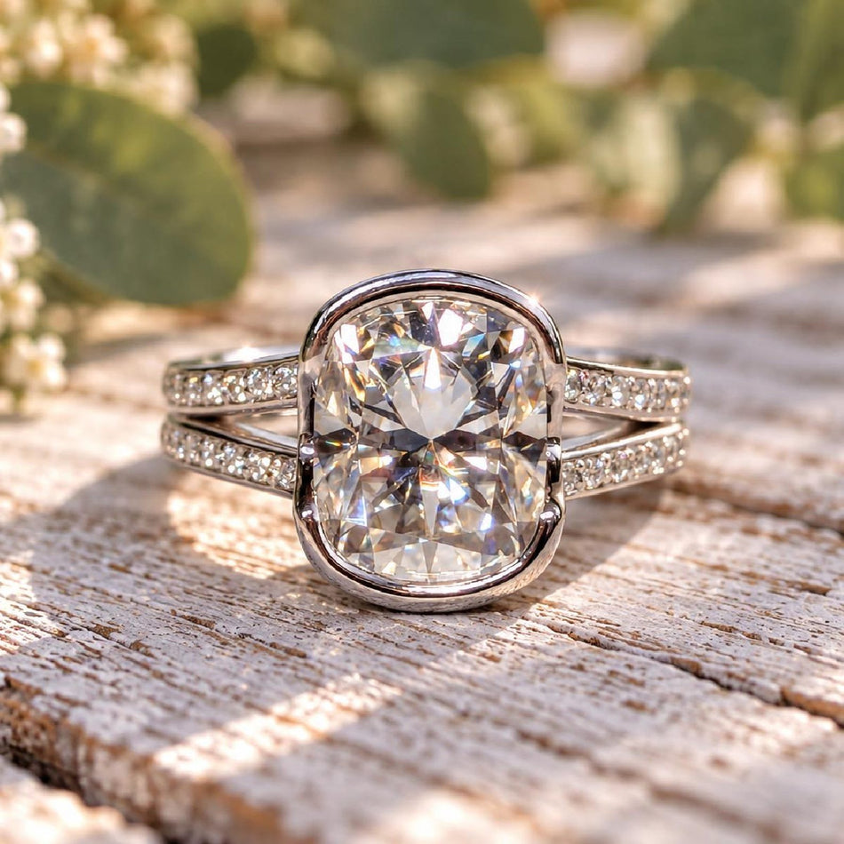 Cushion cut moissanite engagement ring by Bel Viaggio Designs with a diamond-accented band