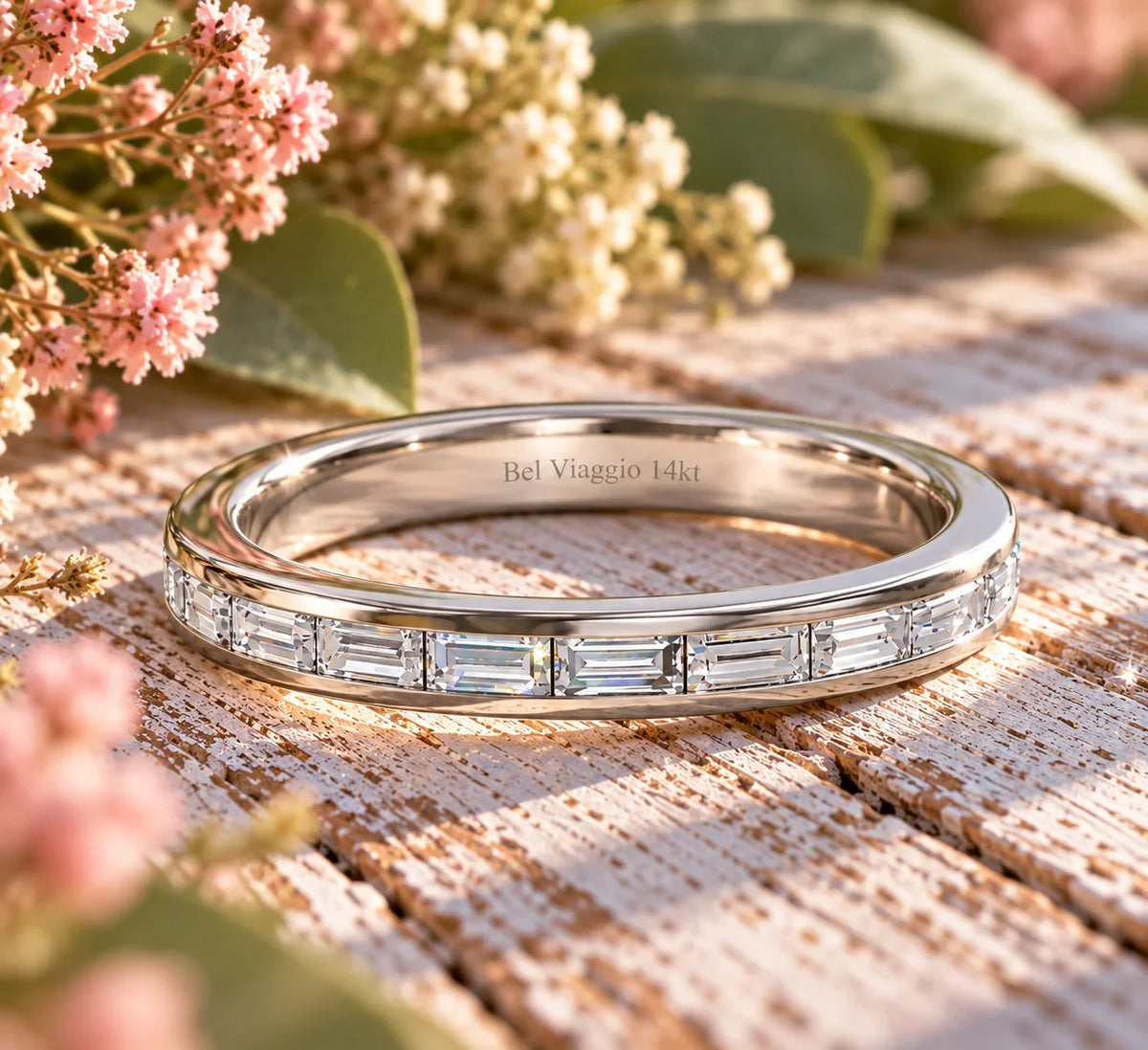 Bel Viaggio Designs lab diamond baguette wedding band in 14kt white gold on a rustic wooden surface