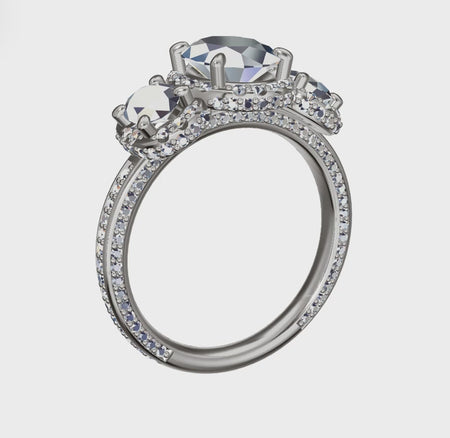 a three stone engagement ring with a center stone surrounded by smaller stones