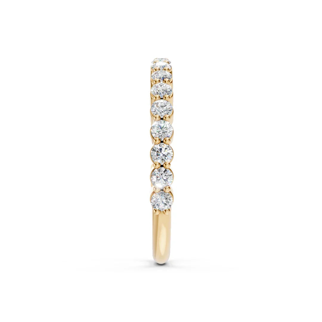 Yellow gold diamond eternity band with round brilliant-cut stones, side view