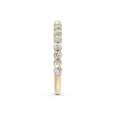 Yellow gold diamond eternity band with round brilliant-cut stones, side view