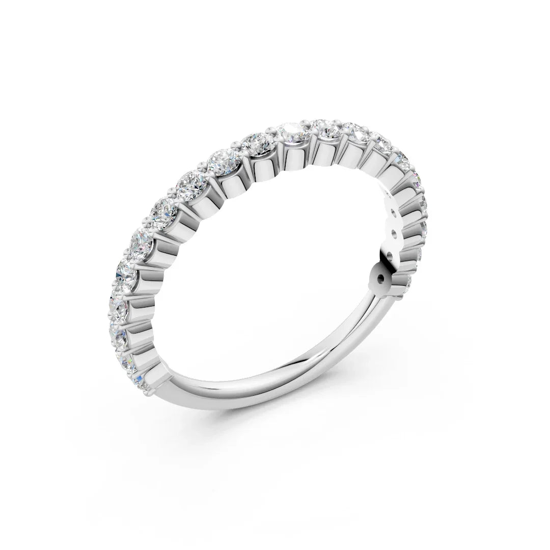 White gold diamond eternity band with round brilliant stones on a white background