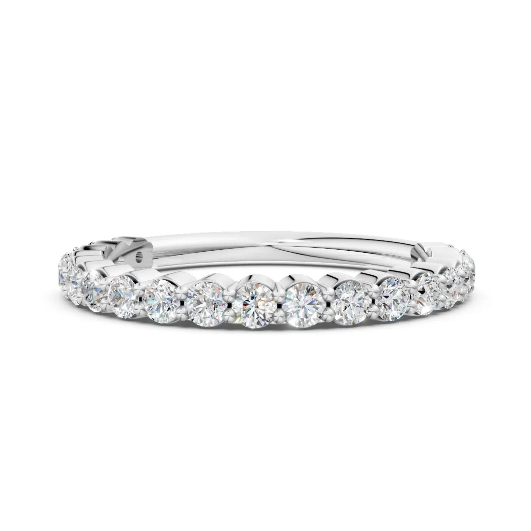 White gold eternity ring with round cut diamonds in prong setting on white background