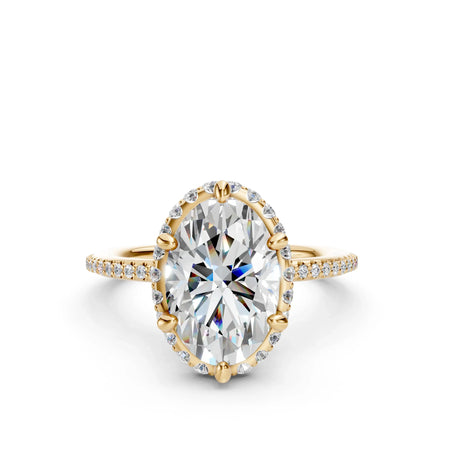 Oval diamond halo engagement ring with gold band and pavé-set accent stones