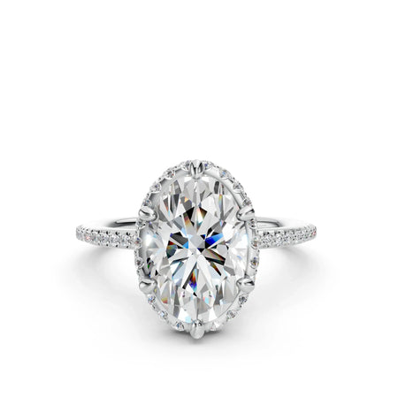 Oval cut diamond engagement ring with pavé band on white background