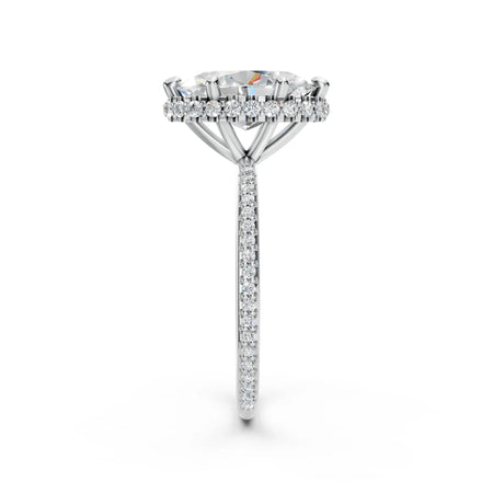 Side view of a diamond engagement ring with pavé band and halo setting