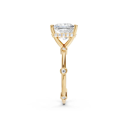 Yellow gold engagement ring with emerald-cut diamond and side accent stones