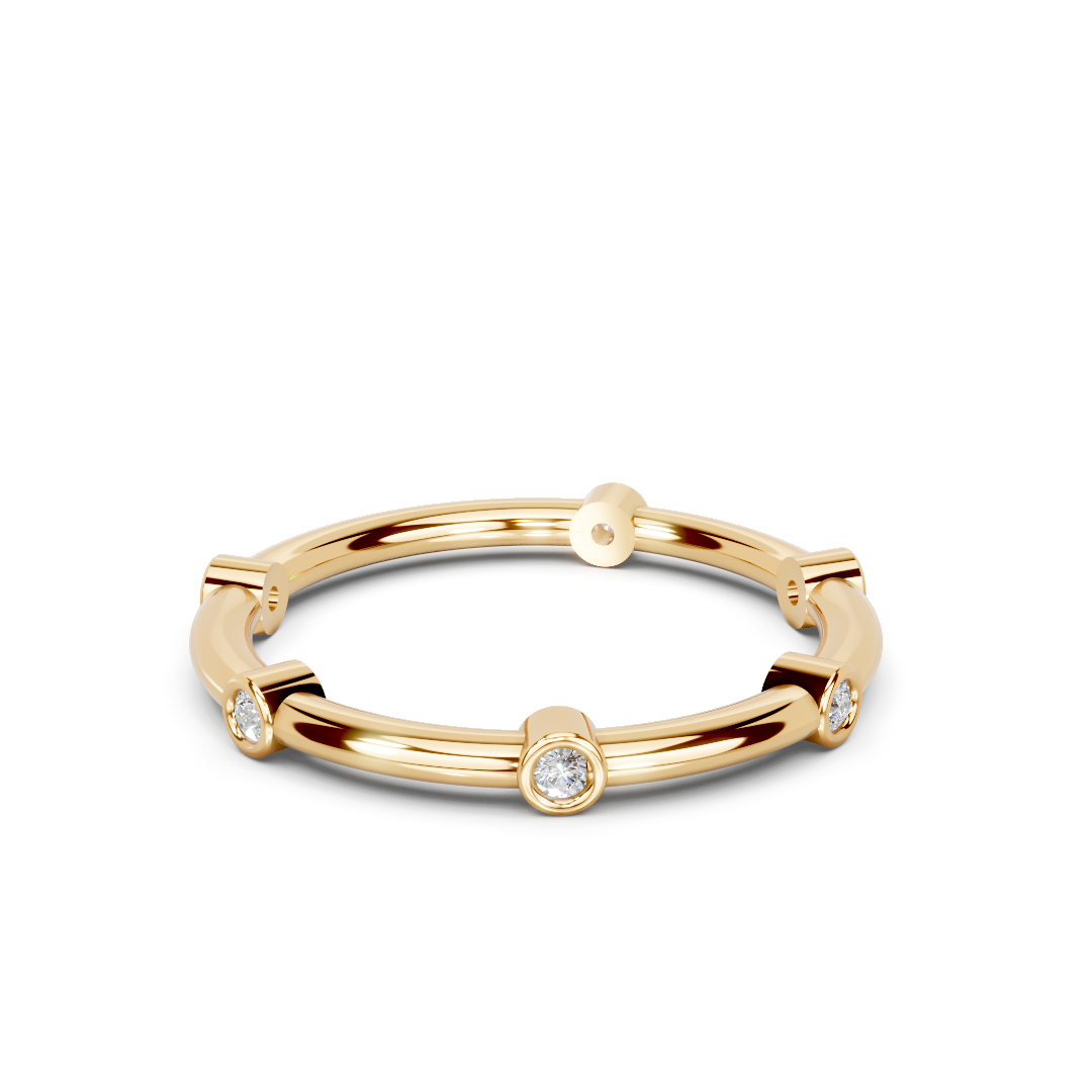 Gold band ring with round bezel-set diamonds in a modern minimalist style