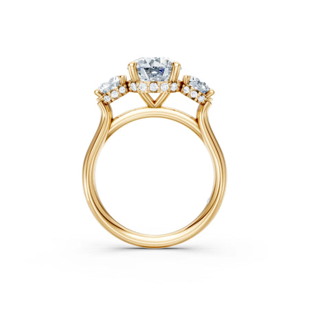 Three-stone yellow gold engagement ring with round diamonds and pavé band, side view