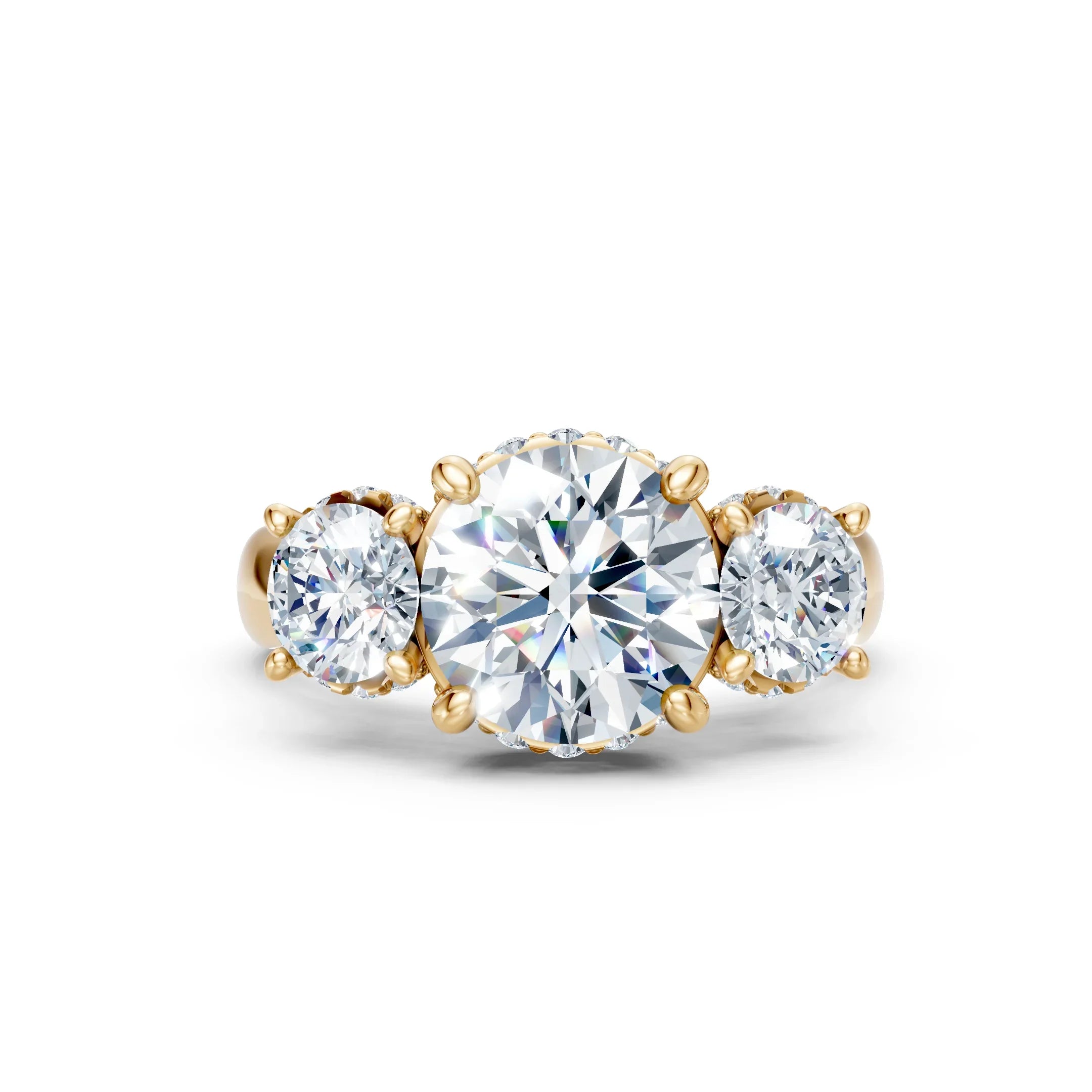 Three-stone gold engagement ring with round brilliant diamonds on white background