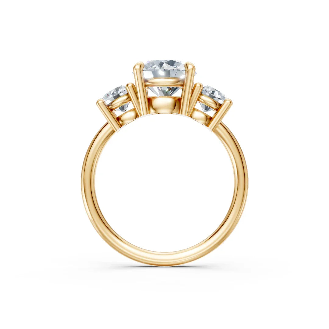 Three-stone gold engagement ring with round diamonds in prong setting on white background