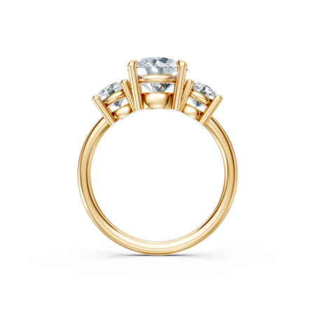Three-stone gold engagement ring with round diamonds in prong setting on white background