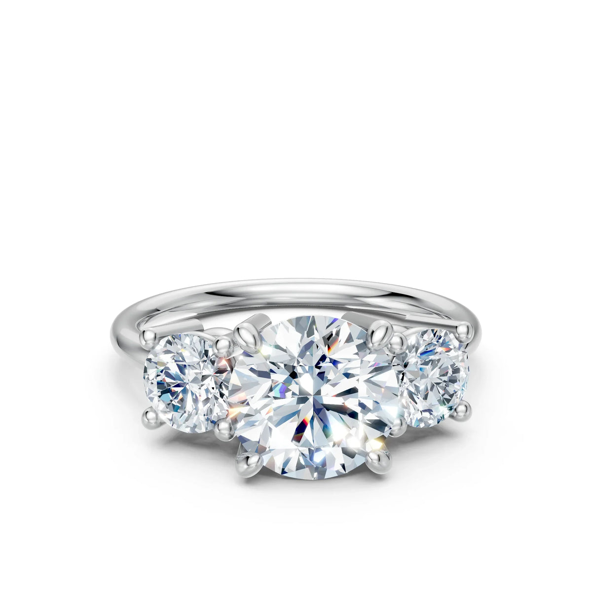 Three-stone diamond engagement ring with round brilliant cut stones on a white gold band