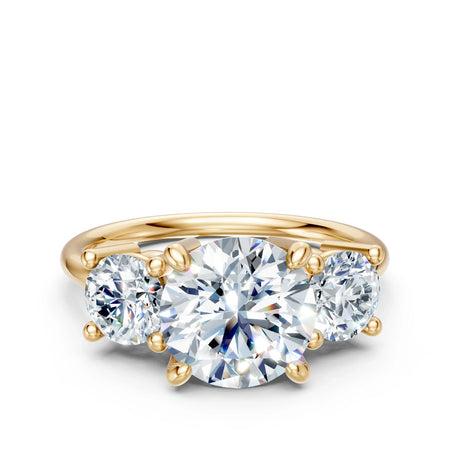 Three-stone gold engagement ring with round brilliant diamonds, custom jewelry design