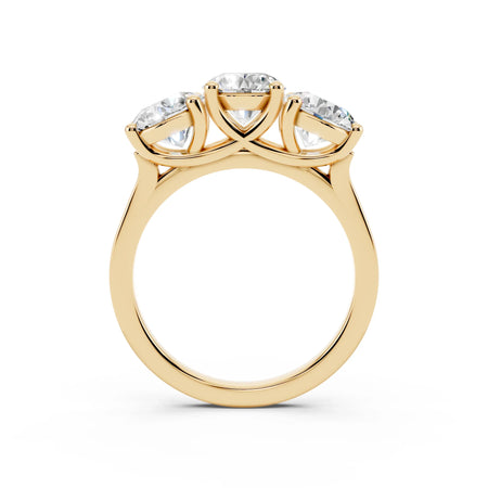 Three-stone yellow gold ring with round diamonds in a custom engagement ring setting
