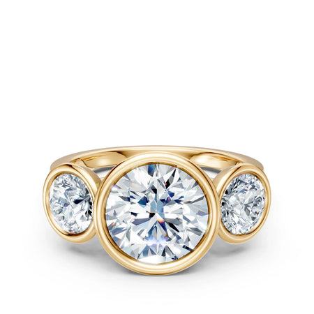 Three-stone round diamond engagement ring in yellow gold bezel setting
