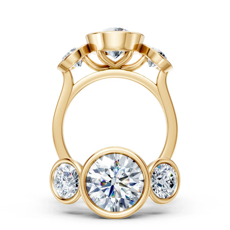 Yellow gold engagement ring with five round-cut diamonds in bezel settings