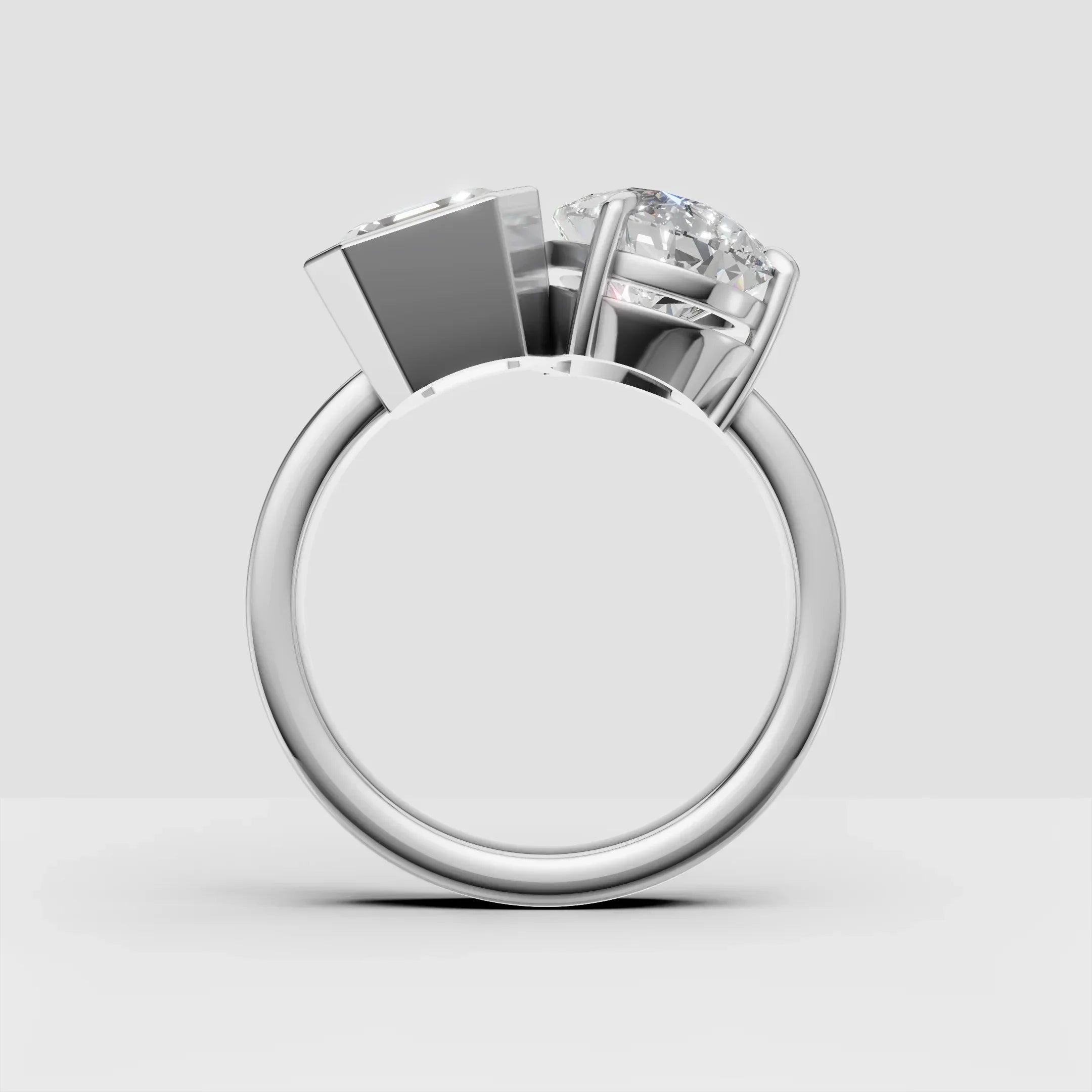 Side view of a custom white gold ring with two round diamonds in modern settings