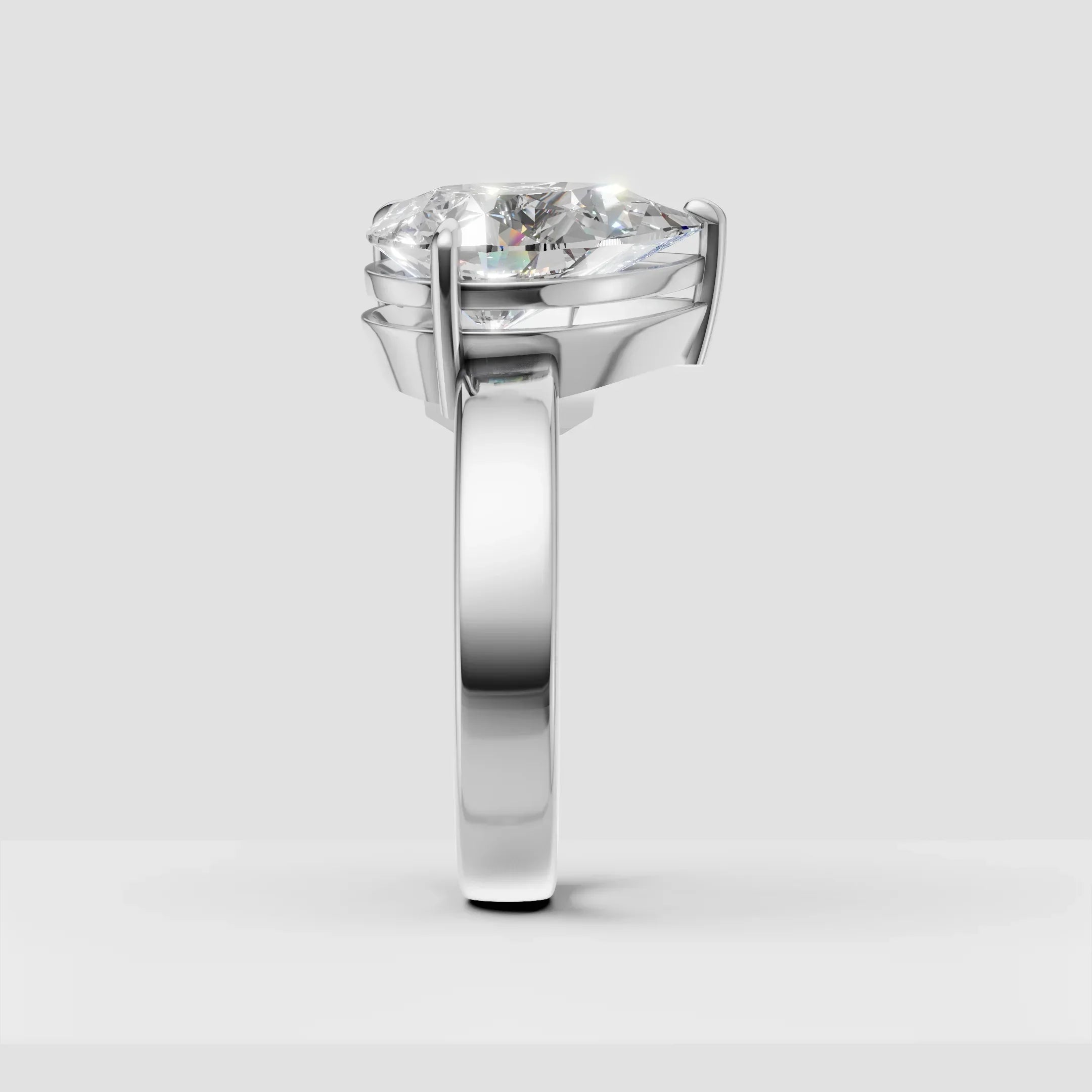 Side view of a solitaire diamond engagement ring with a polished white gold band