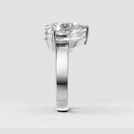 Side view of a solitaire diamond engagement ring with a polished white gold band