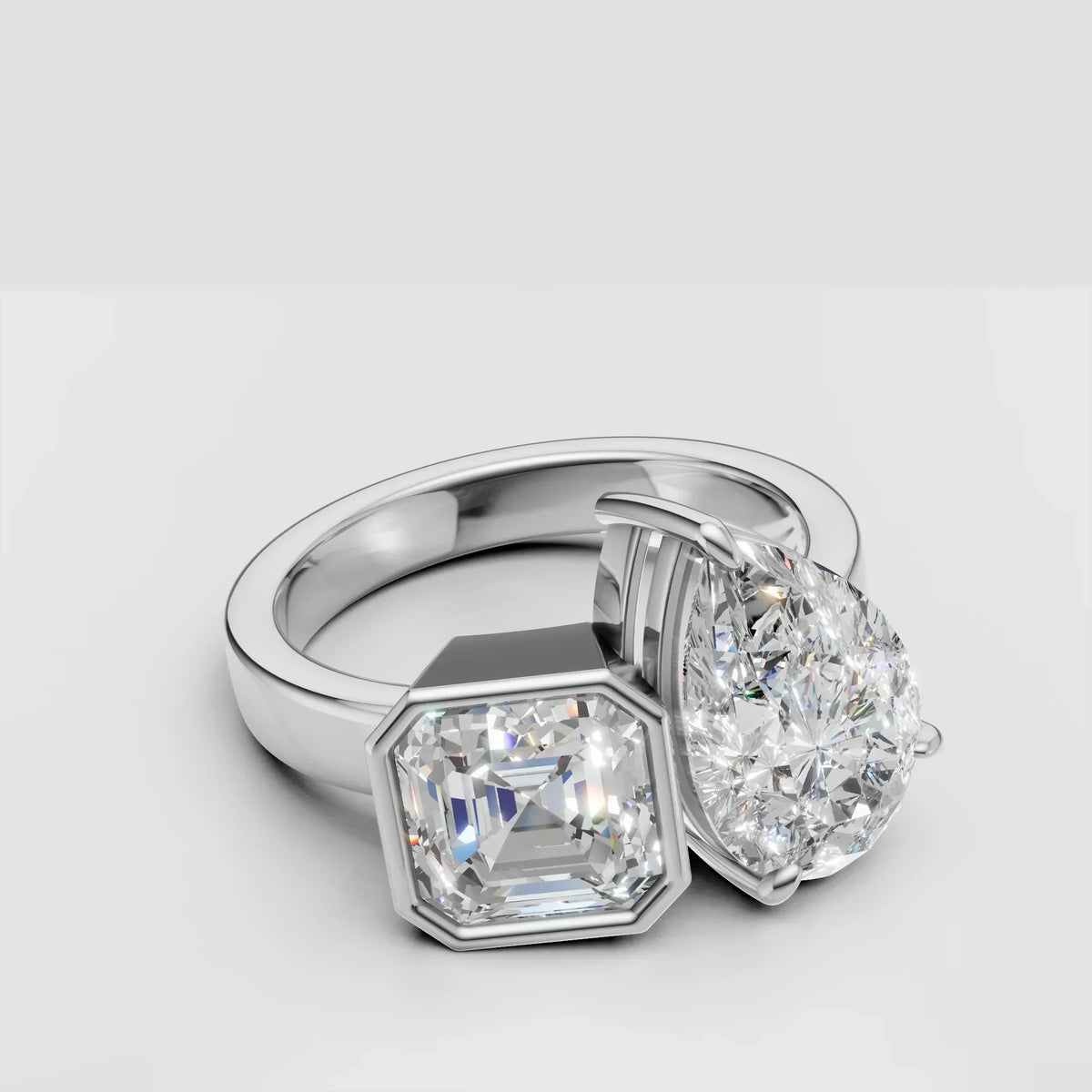 Custom two-stone engagement ring with pear and Asscher cut diamonds in white gold setting