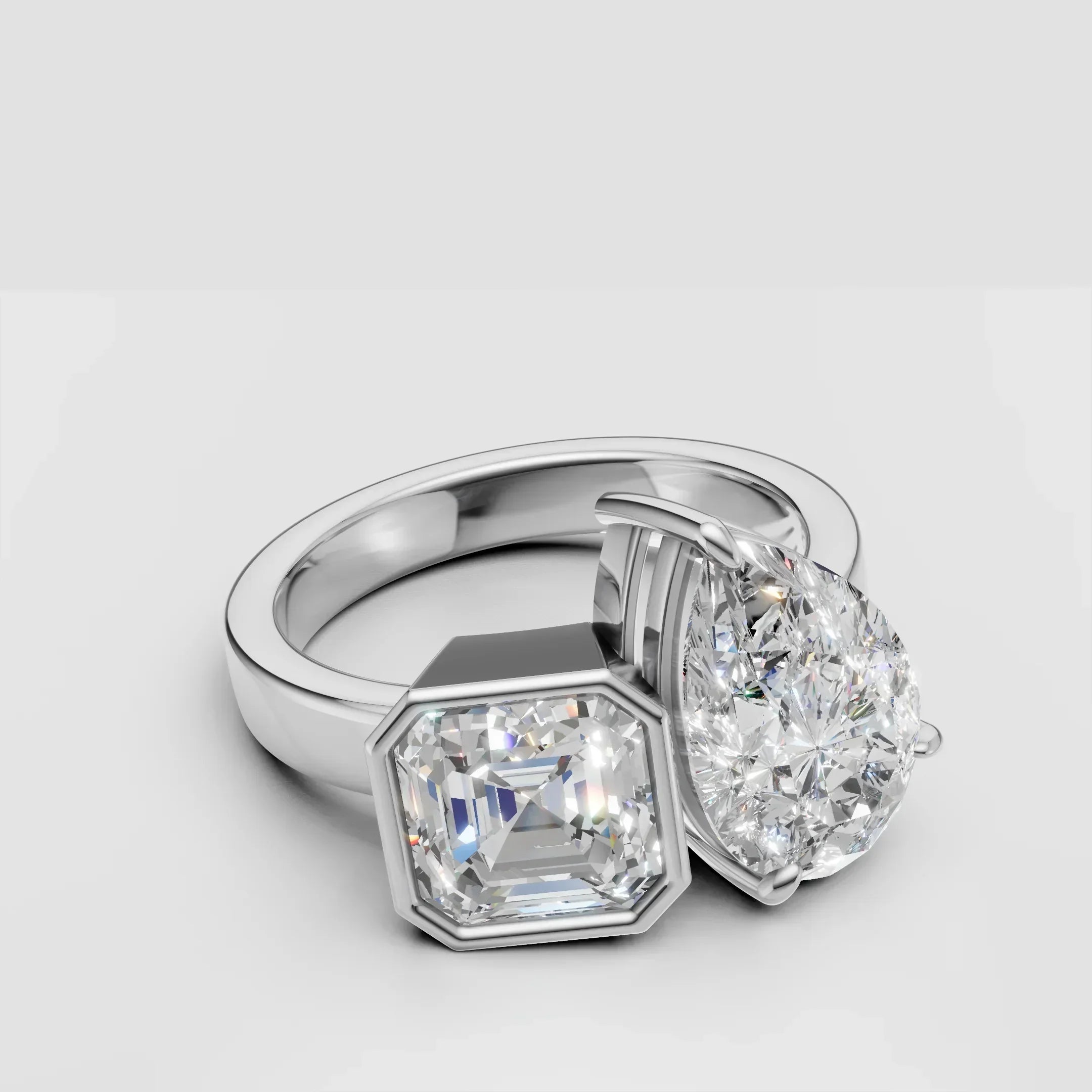 Custom two-stone engagement ring with pear and Asscher cut diamonds in white gold setting