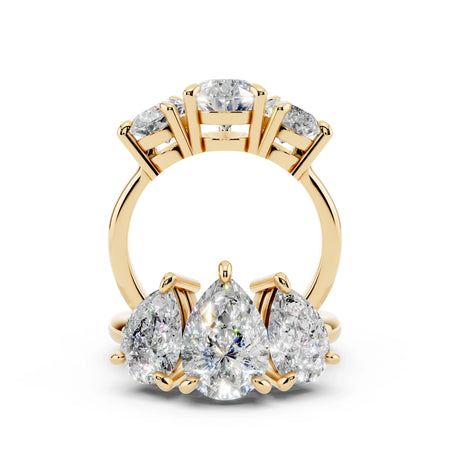 Yellow gold band with three pear-shaped diamonds in custom engagement ring setting
