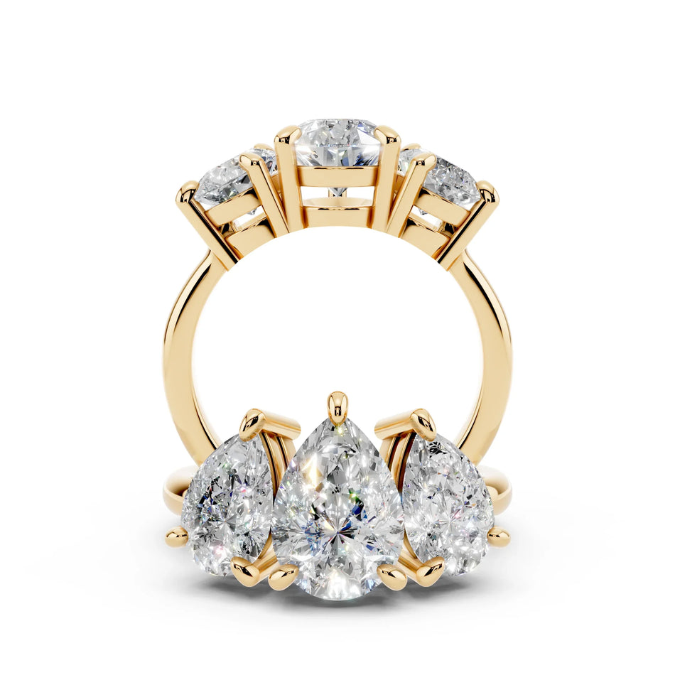 Yellow gold band with three pear-shaped diamonds in custom engagement ring setting