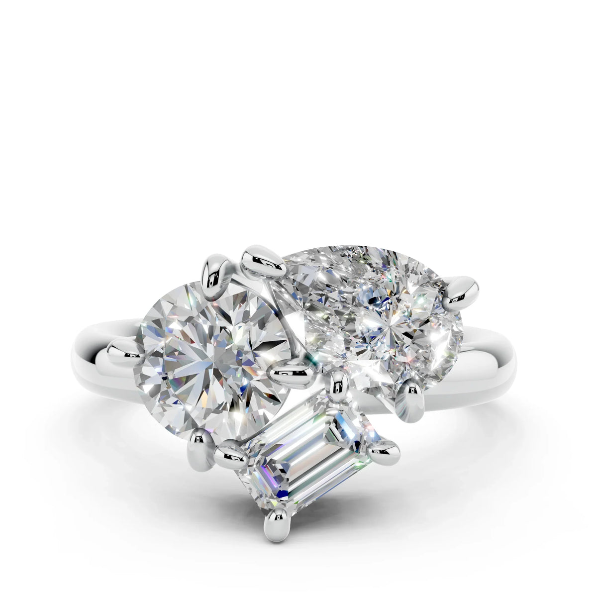 Three-stone diamond engagement ring with round, oval, and emerald-cut diamonds on white gold band