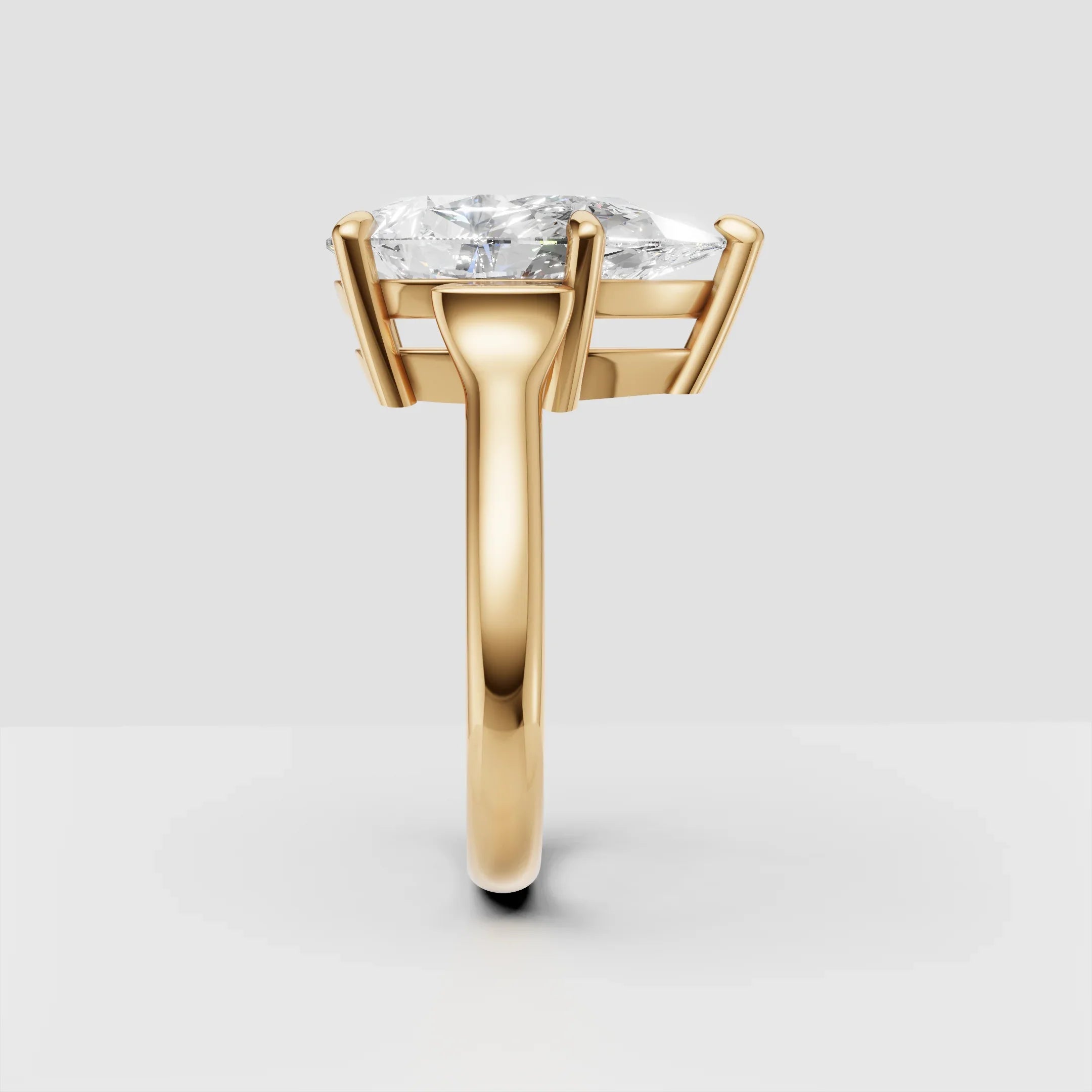 Yellow gold solitaire ring with large round diamond in prong setting, side view