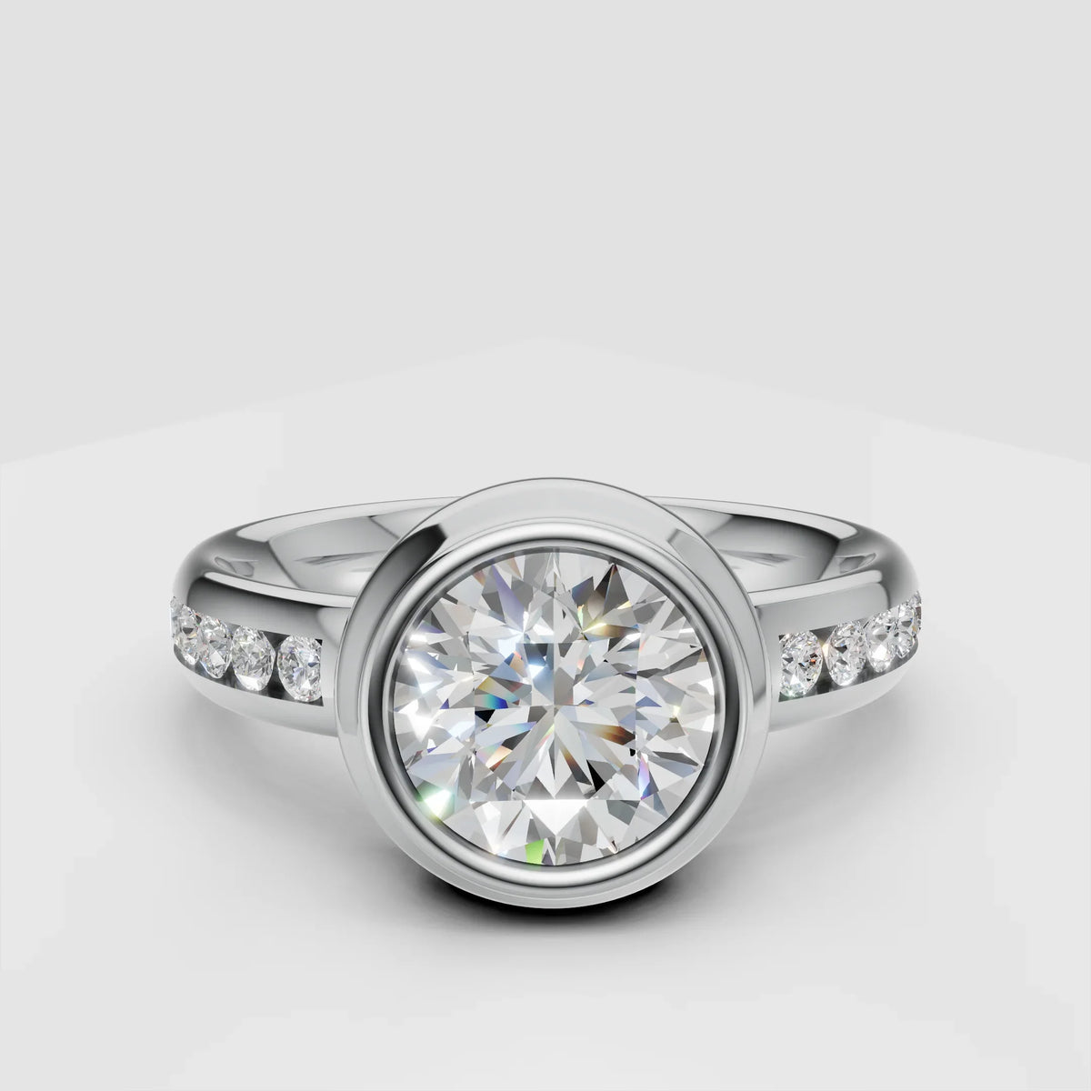 round bezel-set diamond engagement ring with pavé diamond band on white background