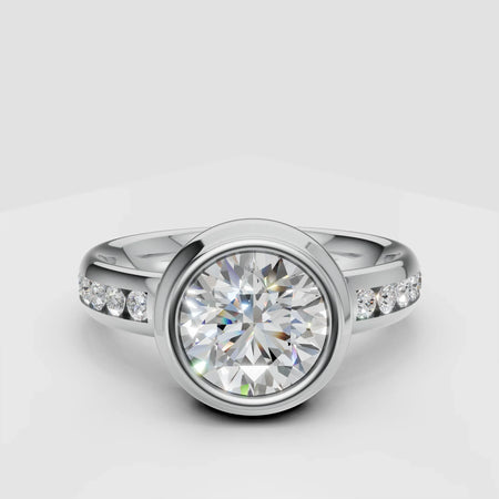 round bezel-set diamond engagement ring with pavé diamond band on white background