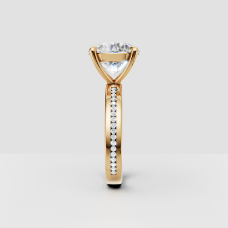Yellow gold engagement ring with round diamond and pavé band, side profile view
