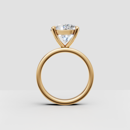 Solitaire diamond engagement ring with gold band on white background