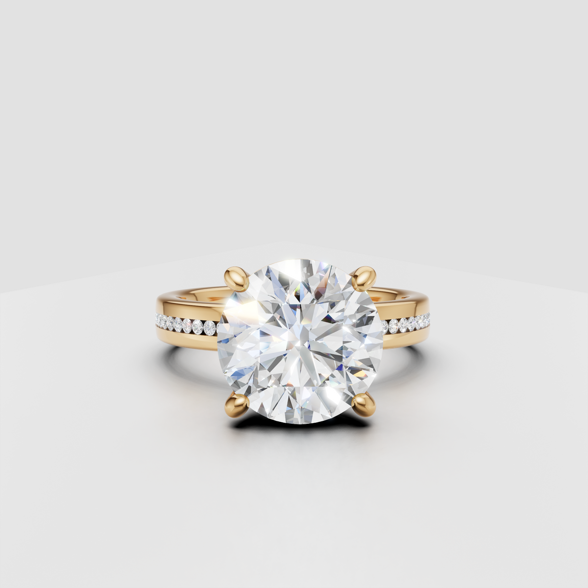 Round solitaire diamond engagement ring with gold band and pavé side stones.