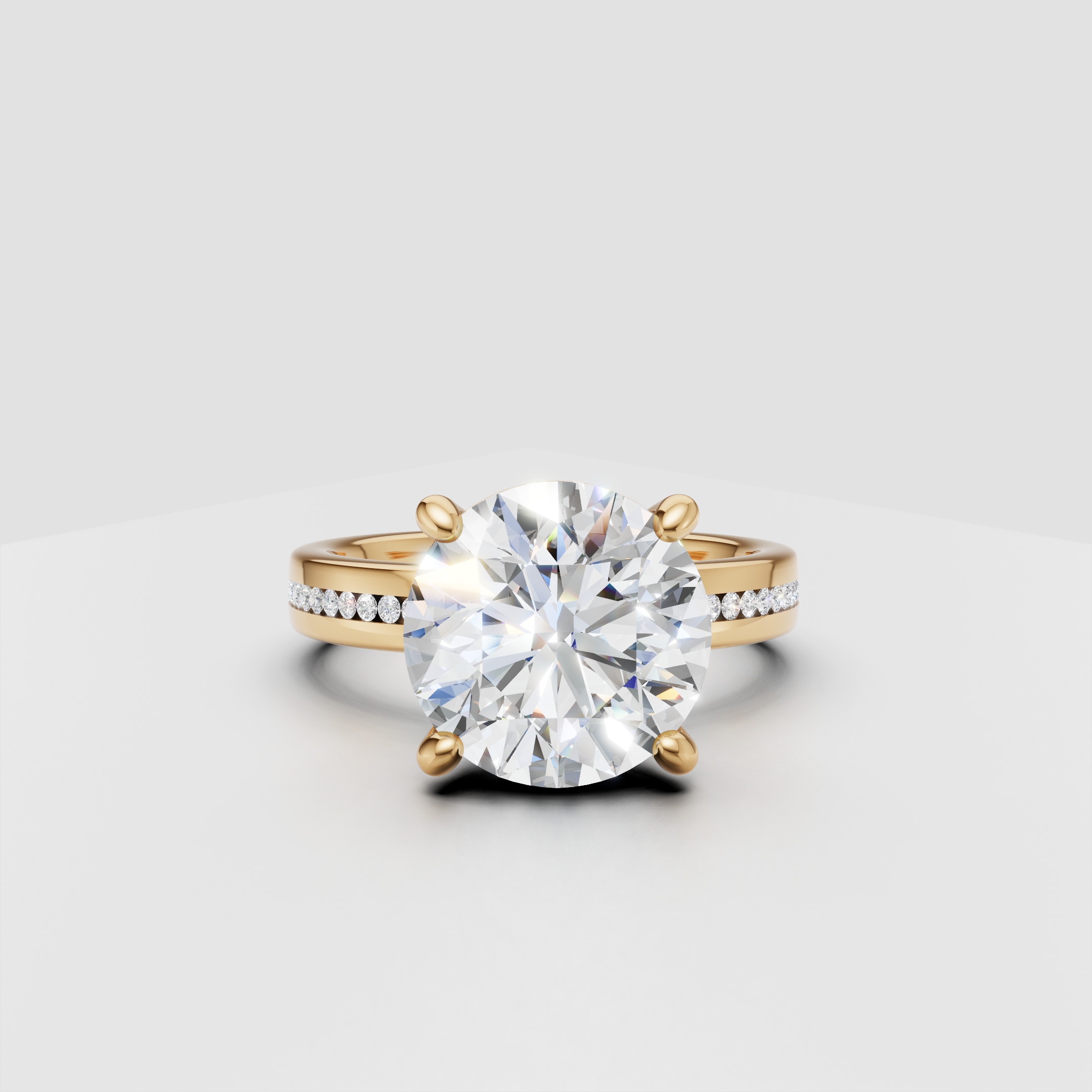 Round solitaire diamond engagement ring with gold band and pavé side stones.
