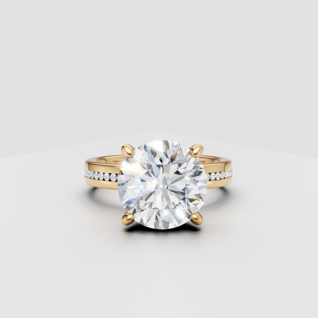 Round solitaire diamond engagement ring with gold band and pavé side stones.