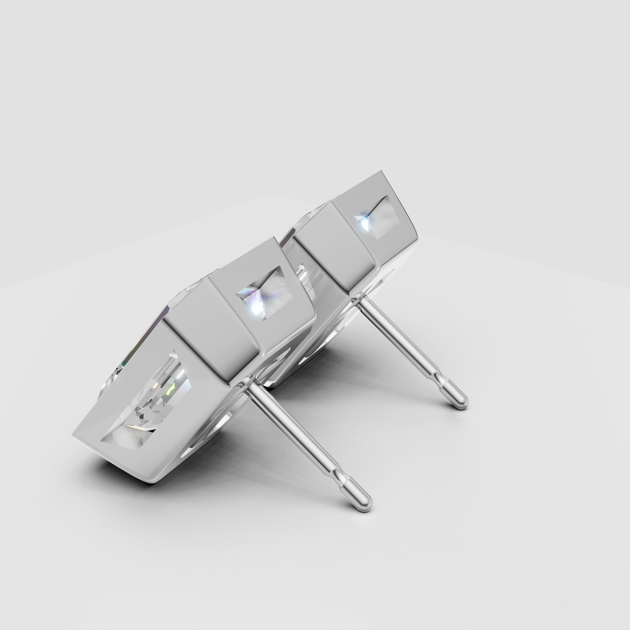 Square-cut diamond stud earrings in white gold setting on white background