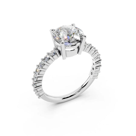 White gold engagement ring with round solitaire diamond and pavé diamond band