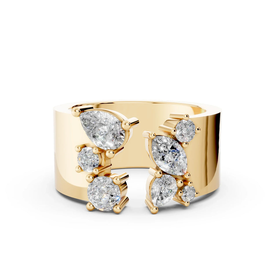 Wide gold band ring with multiple round, pear, and marquise diamonds in modern cluster setting